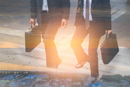 Double exposture of Businessman and Business woman up the stairs in a rush hour to work.の写真素材