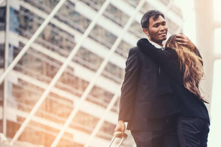 business woman Jump embracing her husband after bonding from business trip at city. Young couple worker. Young businessman in city.の写真素材