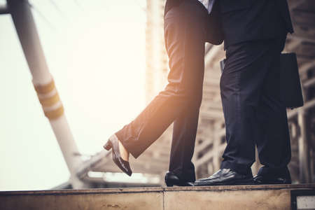 business woman Jump embracing her husband after finish working at city. Young couple worker. Young businessman in city.の写真素材