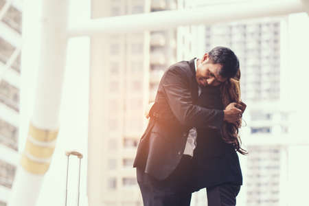 business woman Jump embracing her husband after bonding from business trip at city. Young couple worker. Young businessman in city.の写真素材
