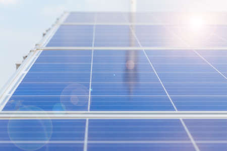 Solar panels or Solar cells on factory rooftop or terrace with sun light, Industry in Thailand, Asia. Can saving energy. Sun or renewable or Clean energy concept.の写真素材