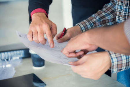 Management consulting and engineers and foreman working with blueprint and drawing on work table for management business plan and construction site project.の写真素材