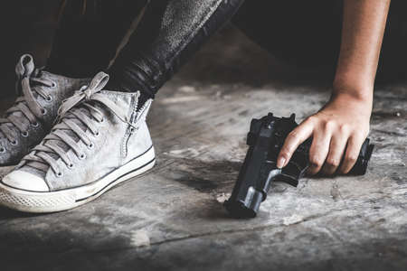 Sad women who are thinking about suicide committed by guns. Social problems concept.の写真素材