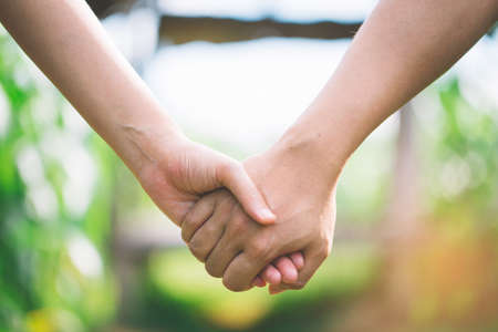 Hand-in-hand. Couple love in forest.の写真素材