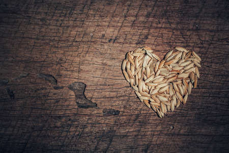 paddy heart symbols on old wooden background. Love organic concept.の写真素材