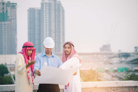 Muslim Business and Engineer working concept: Engineers and two Muslim businessman discussing about...