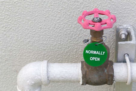 The water valve at the connection steel pipe steel wih normaly open label and water piping system. Manual valve. Old brass valve.の写真素材
