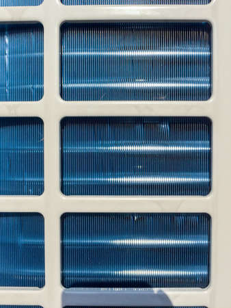 Condenser unit used in central air conditioning systems - heat exchanger (heat micro canel) section to cool down and condensate incoming refrigerant vapor into liquid. background texture. technology.の写真素材