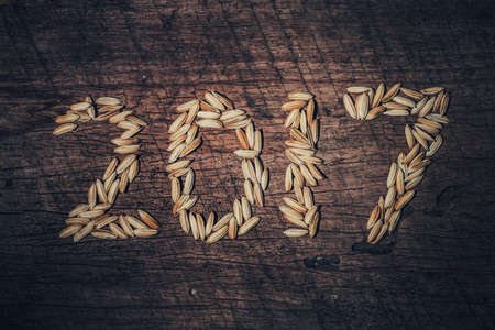 Paddy was arranged word to 2017 A.D. on old wooden background. For Happy New Year 2017.の写真素材