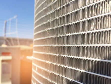 Condenser unit used in central air conditioning systems - heat exchanger (heat micro canel) section to cool down and condensate incoming refrigerant vapor into liquid. background texture. technology.の写真素材