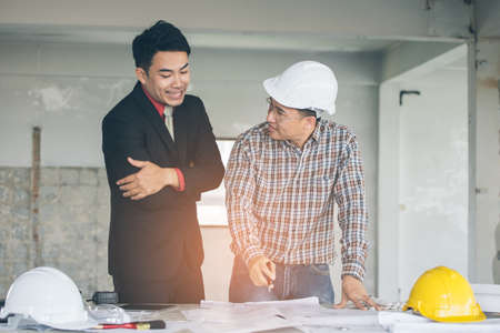 Management consulting with engineers working with blueprint and drawing on work table in for management business plan and construction site project.の写真素材