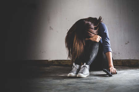 Sad women who are thinking about suicide committed by guns. Social problems concept.の写真素材