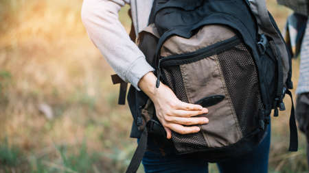 Group of backpacking hikers going to mountain top and navigating by map. Backpackers or Hikers travel concept. Selective focus.の写真素材