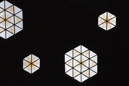 Abstract photo of ceiling with flower in hexagonal window. Modern architecture and interior.の写真素材
