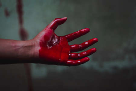 Halloween and horror concept. bloody hand in abandoned house. Photo with grain.の写真素材