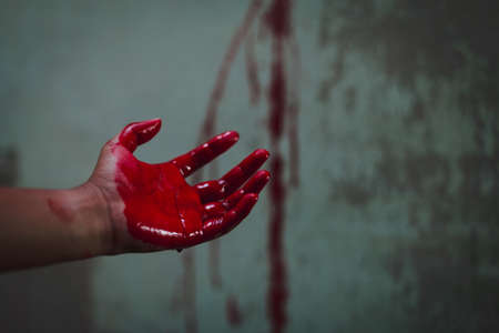Halloween and horror concept. bloody hand in abandoned house. Photo with grain.の写真素材