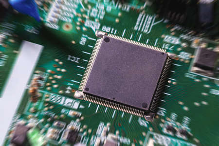 Computer chip on green electronic circuit board or printed circuit board-PCB with electronic...
