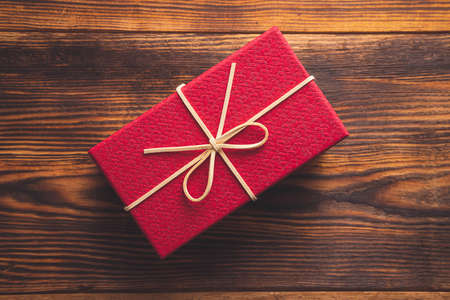 Christmas background, red gift box on wooden backgroundの写真素材