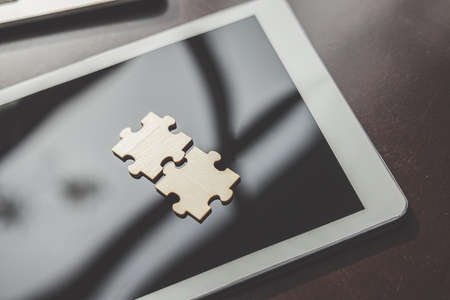 Business solutions, Two piece jigsaw put on tablet. success and strategy and partner concept.の写真素材
