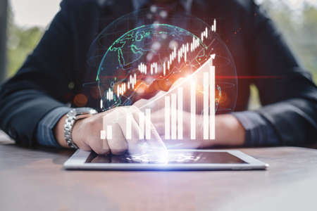 business analytics technology and digital infographic investment financial concept. Businessman use...