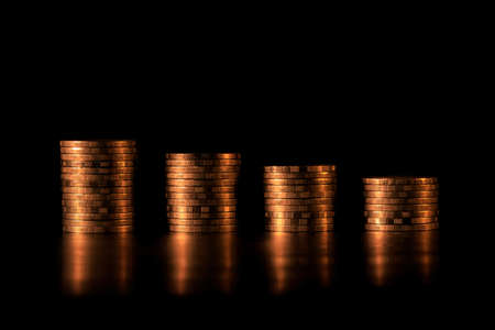 Financial investment  and economic concept. Stack of golden coins in bar chart form on black background. Golden coins bar chart.の写真素材