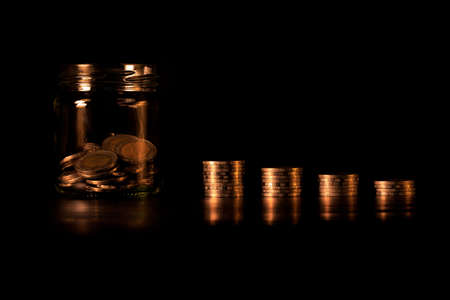 Financial investment  and economic concept. Stack of golden coins in bar chart form on black background. Golden coins bar chart.の写真素材