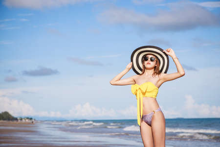 Outdoor summer portrait of the front image of beautiful girls in a sexy bikini standing on the beach in summer. sexy body. concept vacation,  holiday in summerの写真素材