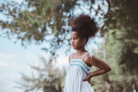portrait of African American girl standing in outdoor park. Confident girlの写真素材