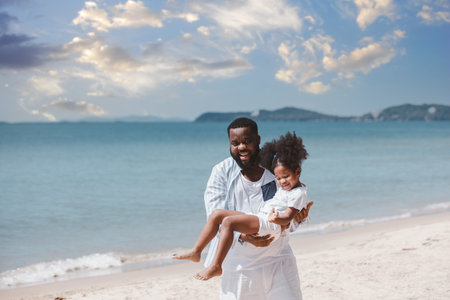 African American father carrying his daughter with cheerful loving. Happy family.の写真素材