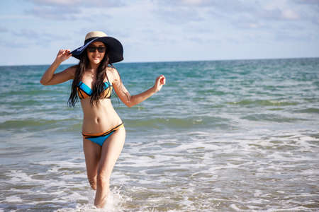 Outdoor summer portrait of the front image of beautiful girls in a sexy bikini standing on the beach in summer. sexy body. concept vacation,  holiday in summerの写真素材
