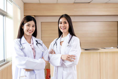 portrait of smart female doctor with a Stethoscope standing at reception of the hospital.の写真素材