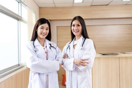 portrait of smart female doctor with a Stethoscope standing at reception of the hospital.の写真素材
