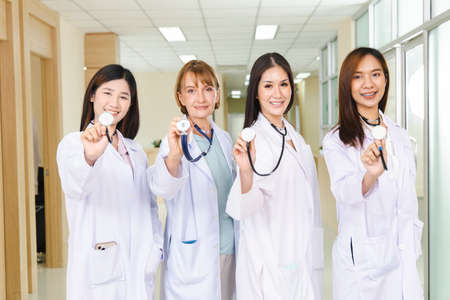 portrait of smart female doctor with a Stethoscope standing at reception of the hospital.の写真素材