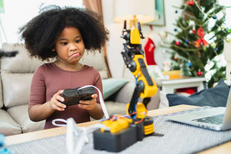 Two African American girls learned robot arms with a program computer. Innovative technology mechanical for Assistive Technologyの写真素材