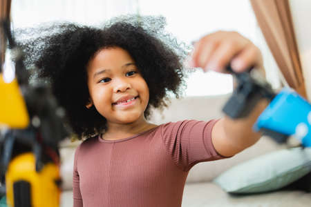 African American girl learning robotic arms with a program computer. Innovative technology mechanical for Assistive Technologyの写真素材