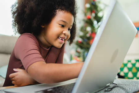 African American girl have fun working together while studying online using computers at home.の写真素材