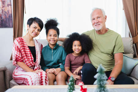 Happy family have fun sitting together on the sofa at home. cheerful young family with children...