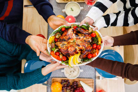 African American family. Merry Christmas. Happy family are having dinner at home. Celebration holiday and togetherness near Christmas tree.の写真素材