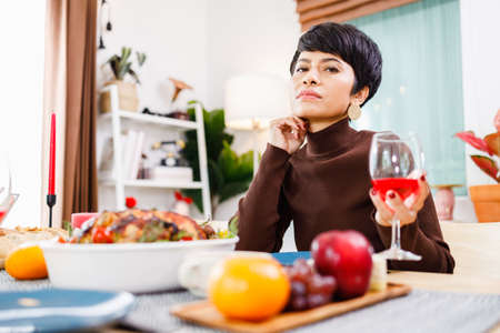 Portrait of a confident woman celebrating Christmas day alone at home.の写真素材