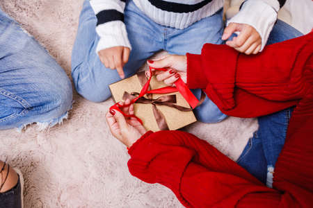 family help wrapping gift box, celebration holiday Christmasâs day. Modern lifestyle people love fun together with childhood conception. Merry Christmas.の写真素材