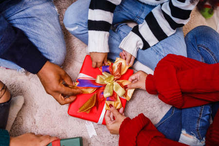 family help wrapping gift box, celebration holiday Christmasâs day. Modern lifestyle people love fun together with childhood conception. Merry Christmas.の写真素材