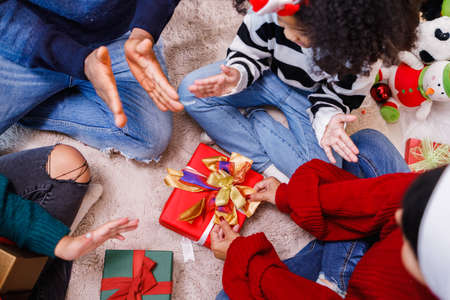 family help wrapping gift box, celebration holiday Christmasâs day. Modern lifestyle people love fun together with childhood conception. Merry Christmas.の写真素材