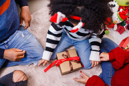 family help wrapping gift box, celebration holiday Christmasâs day. Modern lifestyle people love fun together with childhood conception. Merry Christmas.の写真素材