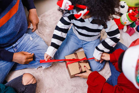 family help wrapping gift box, celebration holiday Christmasâs day. Modern lifestyle people love fun together with childhood conception. Merry Christmas.の写真素材