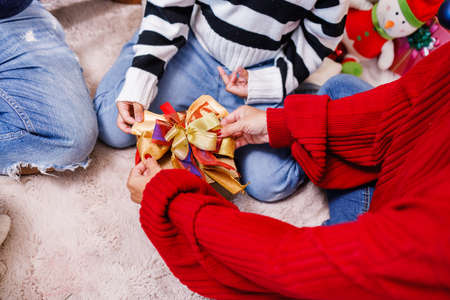 family help wrapping gift box, celebration holiday Christmasâs day. Modern lifestyle people love fun together with childhood conception. Merry Christmas.の写真素材