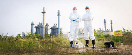 Portrait of Two Environmental Scientists in protective suits and masks from industrial. Environment Issue concept. Banner sizeの写真素材