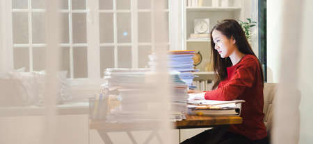 Asian Employee overtime working at home, Workaholic people, Shot from the windowの写真素材