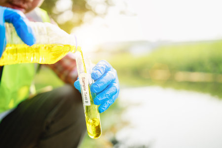 Hands of scientists testing wastewater samples from the industrial estate. Healthcare and Medicalの写真素材
