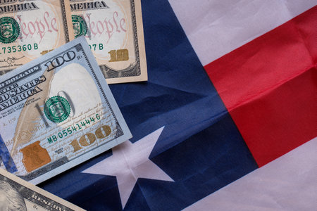 US dollar bills are stacked on an American flag. Global financial - us dollars conceptの写真素材