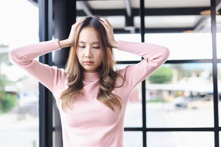 Woman was sick with head ache while standing. Healthy of woman concept. Stressed because pain and migraineの写真素材